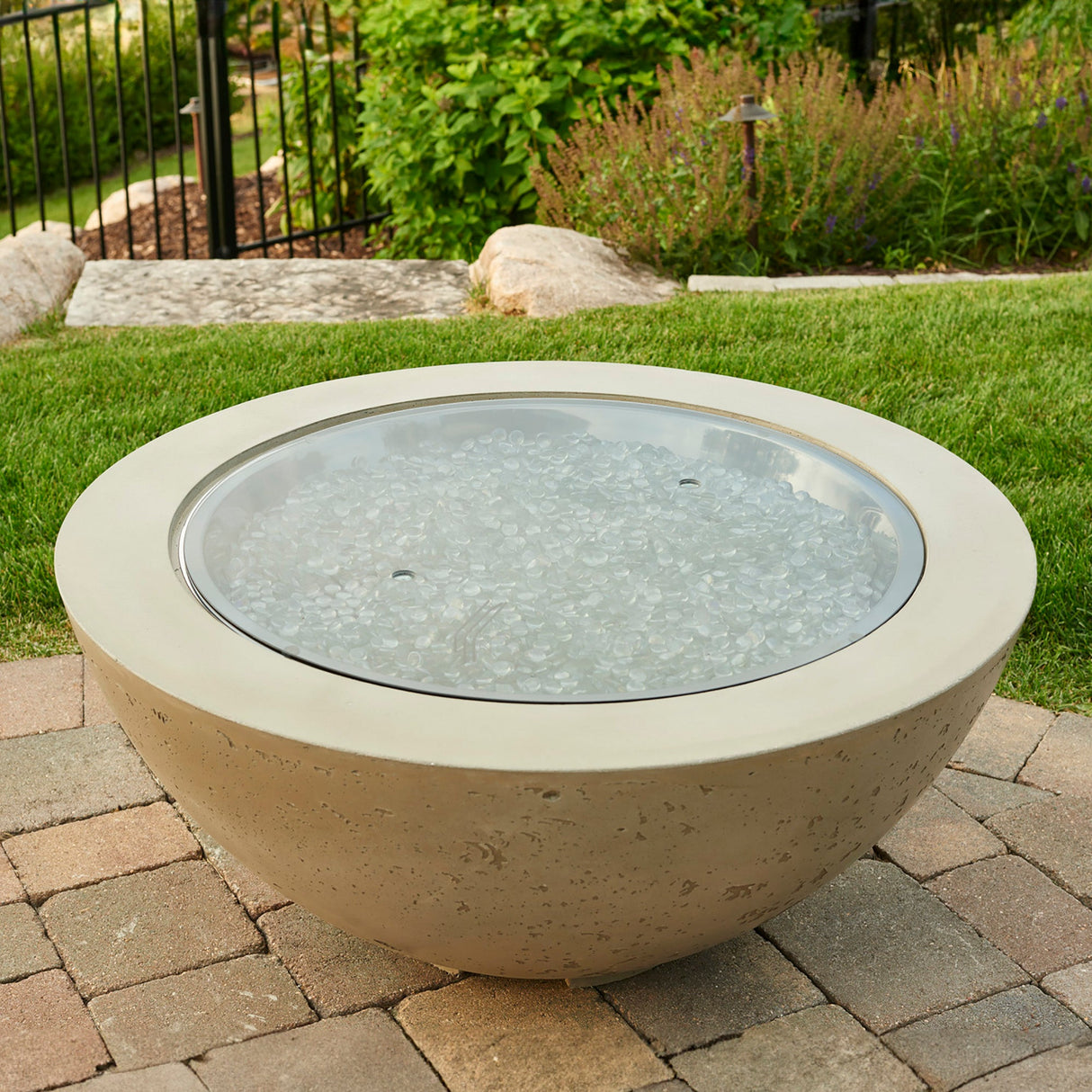 The 30" Round Glass Burner Cover covering a fire pit bowl