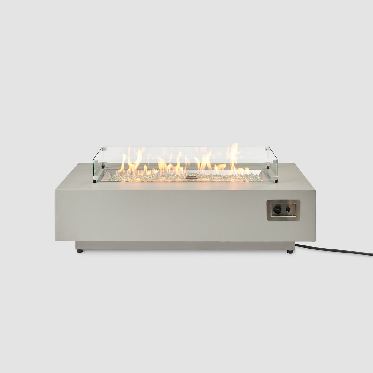 A front view of the Harbor View Rectangular Gas Fire Pit Table with a glass wind guard on the burner