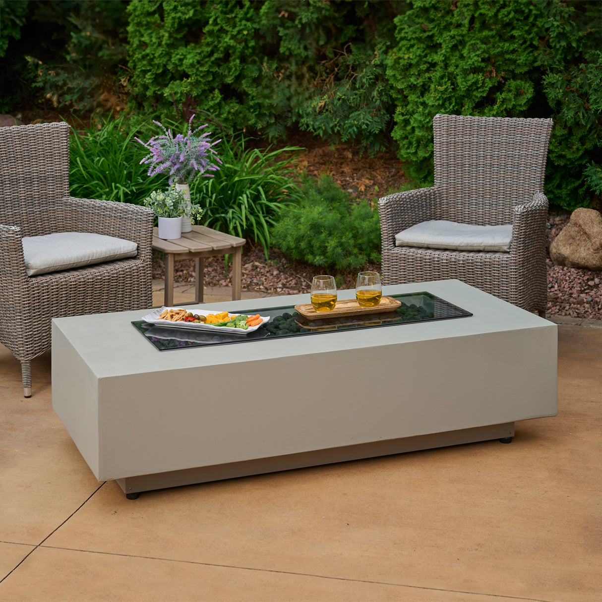 The Harbor View Rectangular Gas Fire Pit Table with food and drink on the top of the glass cover on top