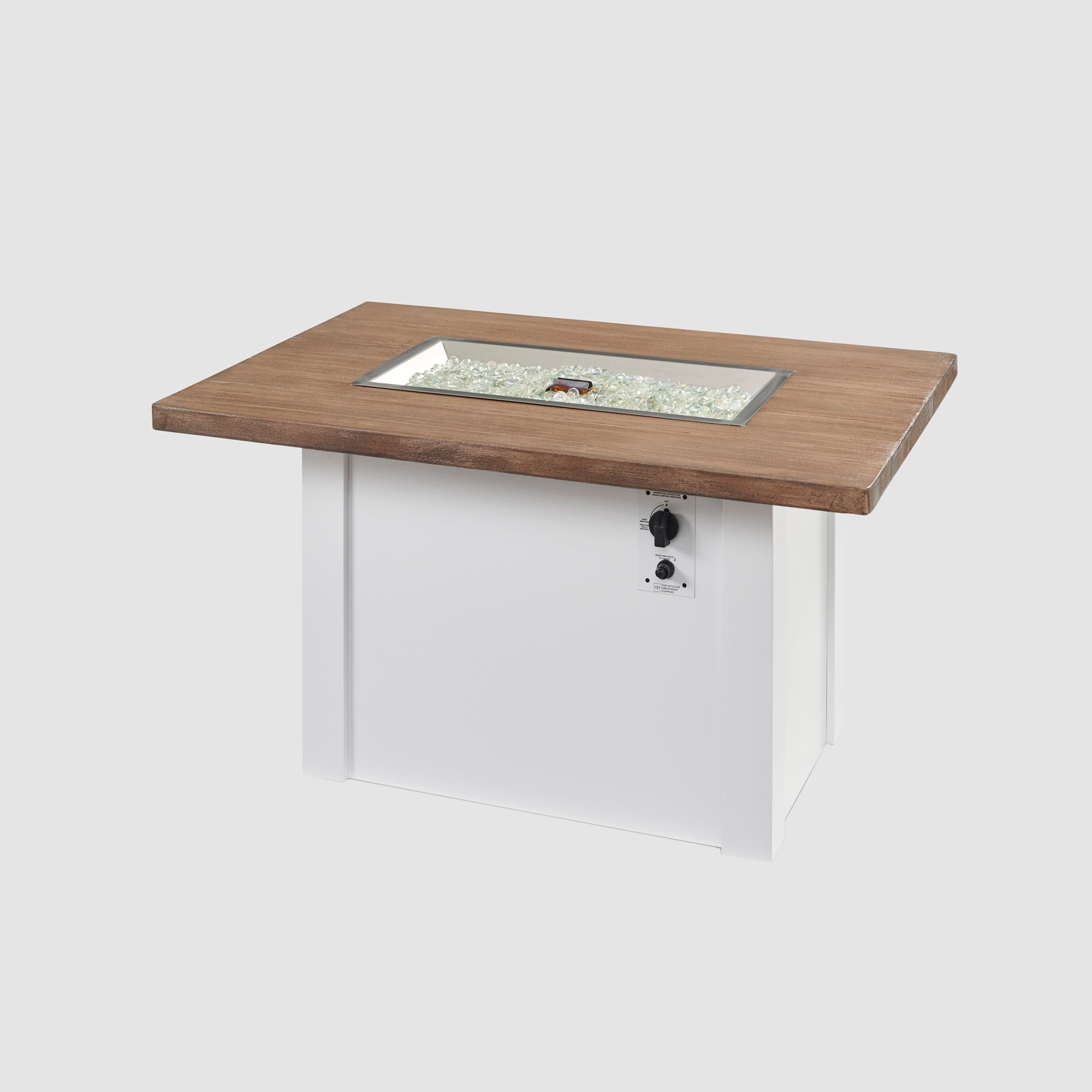 Fire gems covering the burner of a Havenwood Rectangular Gas Fire Pit Table with a Driftwood top and White base