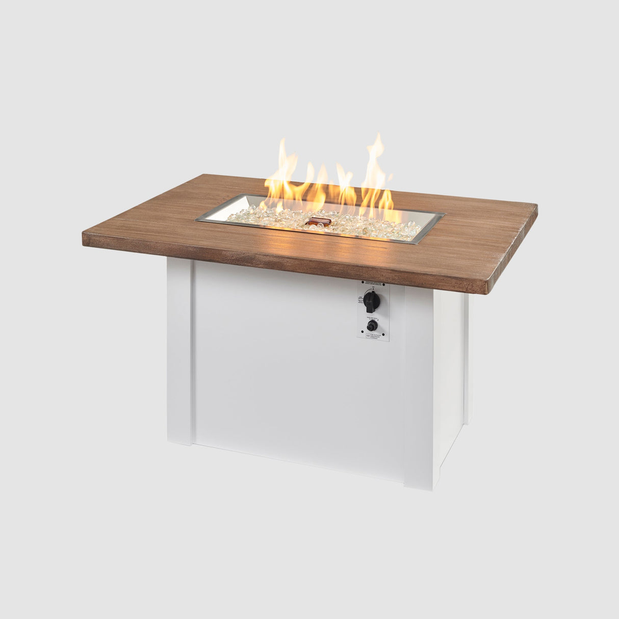 A large flame coming off the burner of a Havenwood Rectangular Gas Fire Pit Table with a Driftwood top and White base