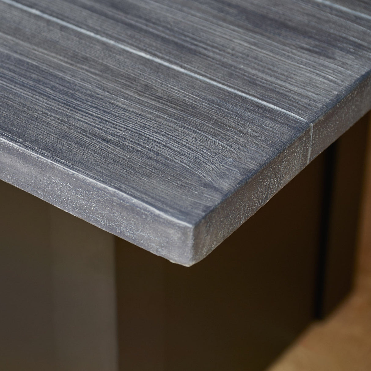 A view of the detail found on the top of a Havenwood Linear Gas Fire Pit Table with a Carbon Grey top and Luverne Black base
