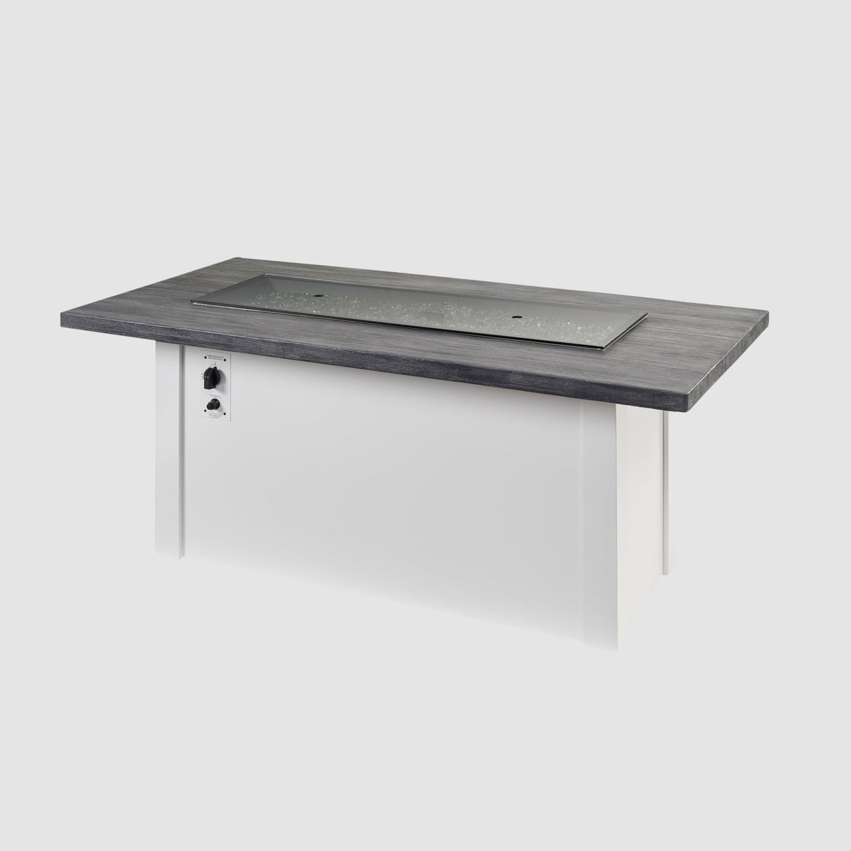 A cover placed on the burner of a Havenwood Linear Gas Fire Pit Table with a Carbon Grey top and White base