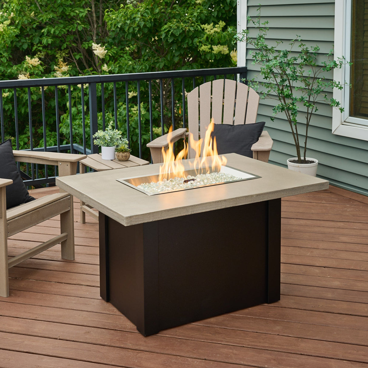 A large flame coming from the burner of a Havenwood Rectangular Gas Fire Pit Table