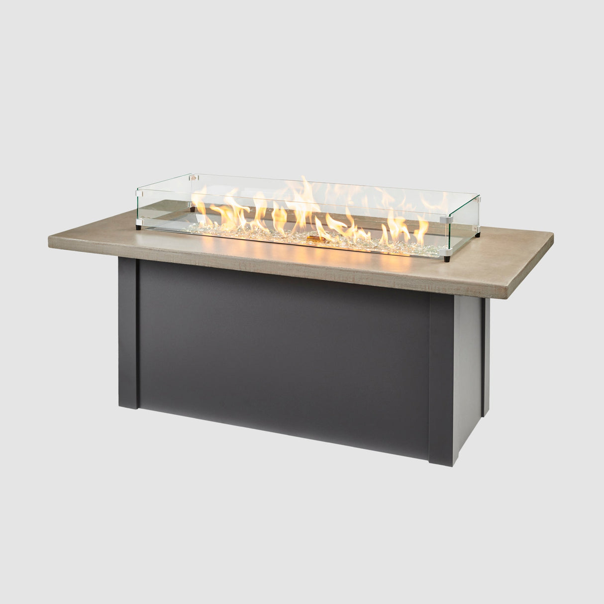 A glass wind guard placed on top of a Havenwood Linear Gas Fire Pit Table with a Pebble Grey top and Graphite Grey base