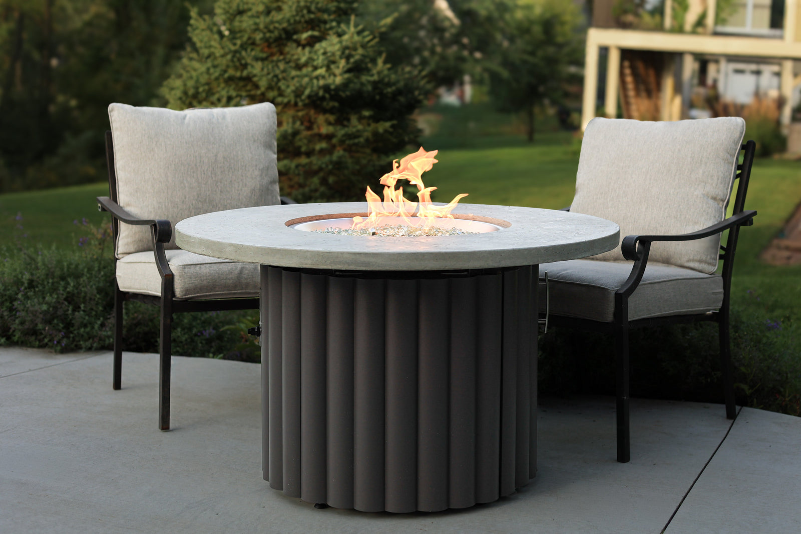 A 42" Reverie Gas Fire Table with Relic Grey Supercast Top and Charcoal Grey Scalloped Aluminum Base