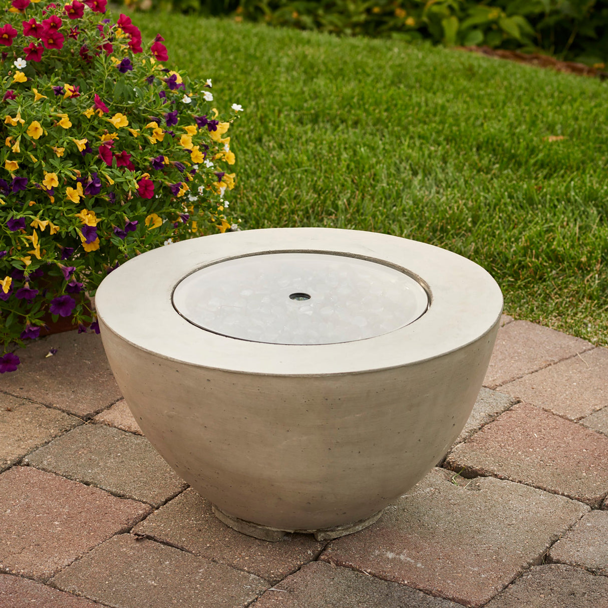 The 12" Round Glass Burner Cover being used on a fire pit bowl