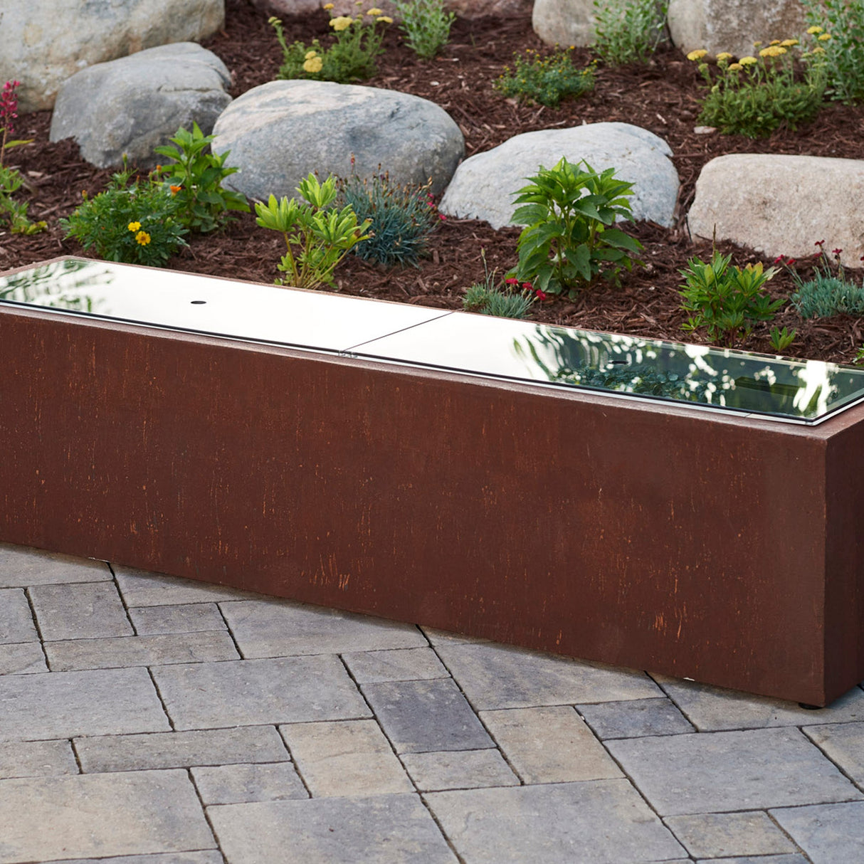 The Linear Glass Burner Cover being used on a linear fire pit table