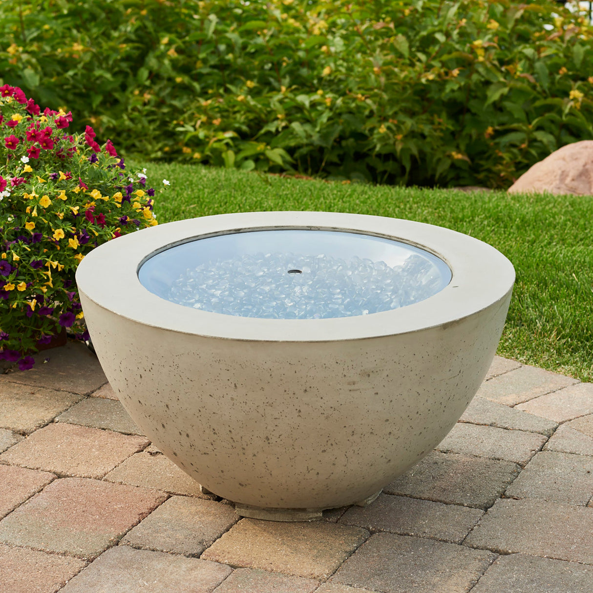 The 20" Round Glass Burner Cover on a Cove Fire Pit Bowl