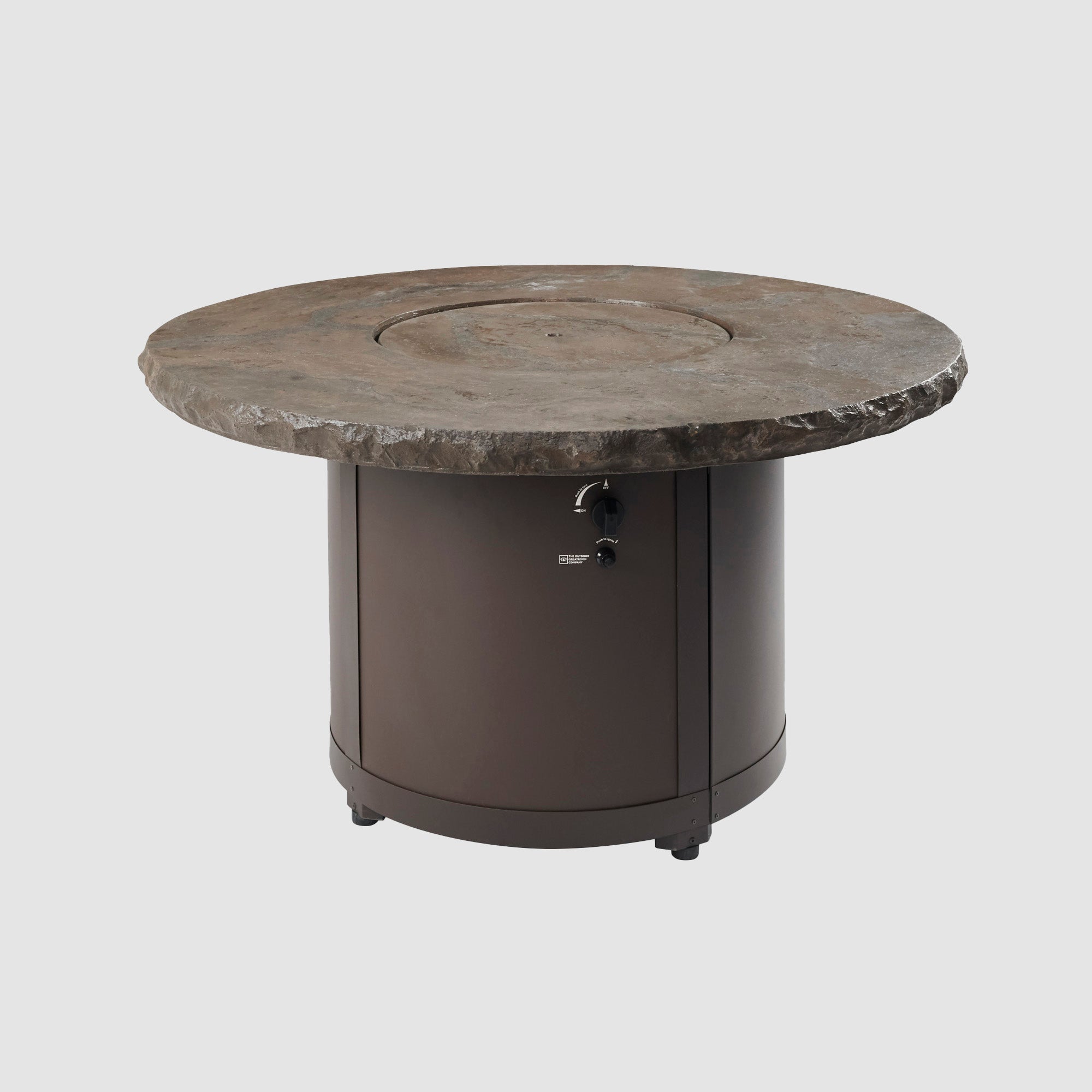 The Marbleized Noche Beacon Round Gas Fire Pit Table on a patio setting with its cover on