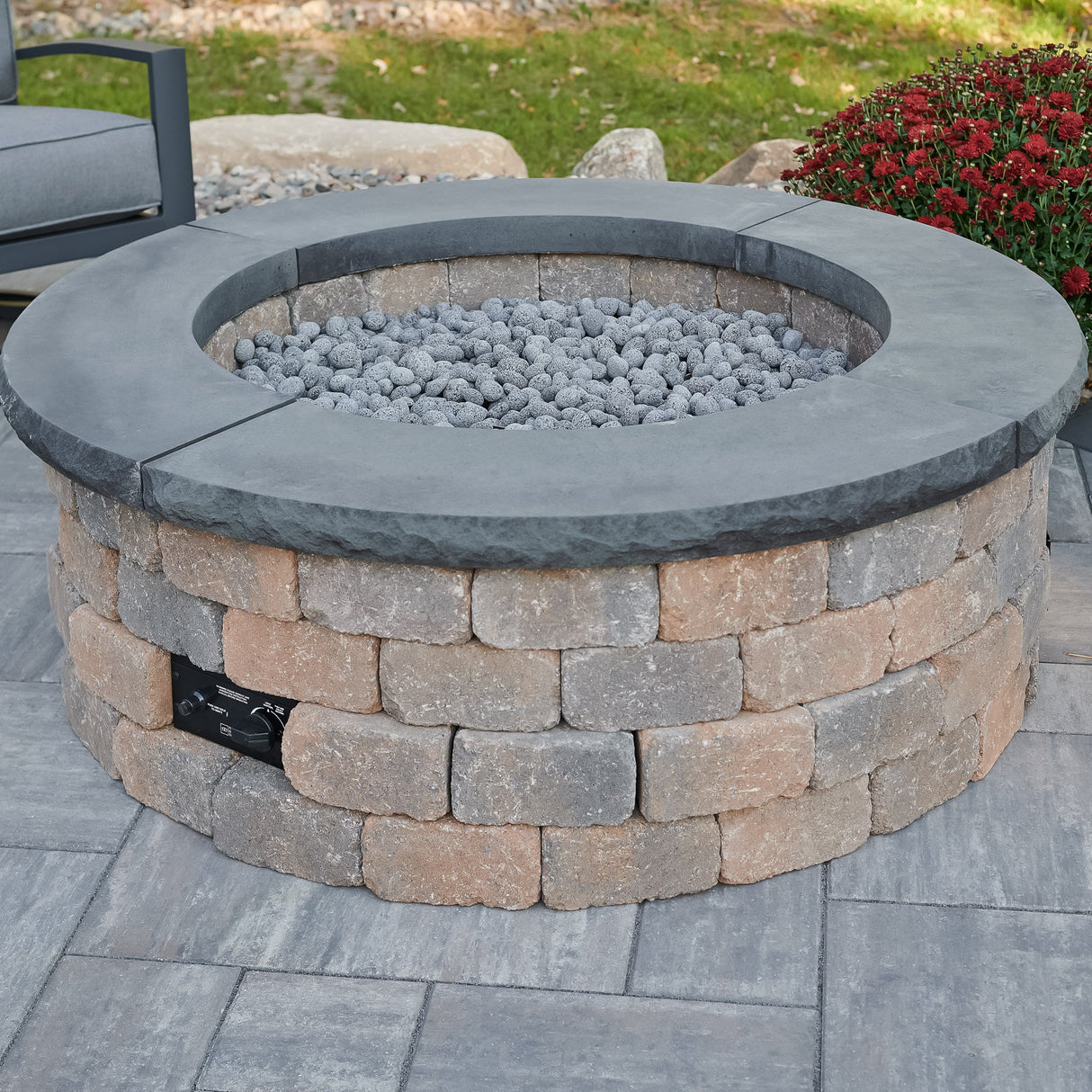 A close up of the Bronson Block Round Gas Fire Pit Kit and its control panel