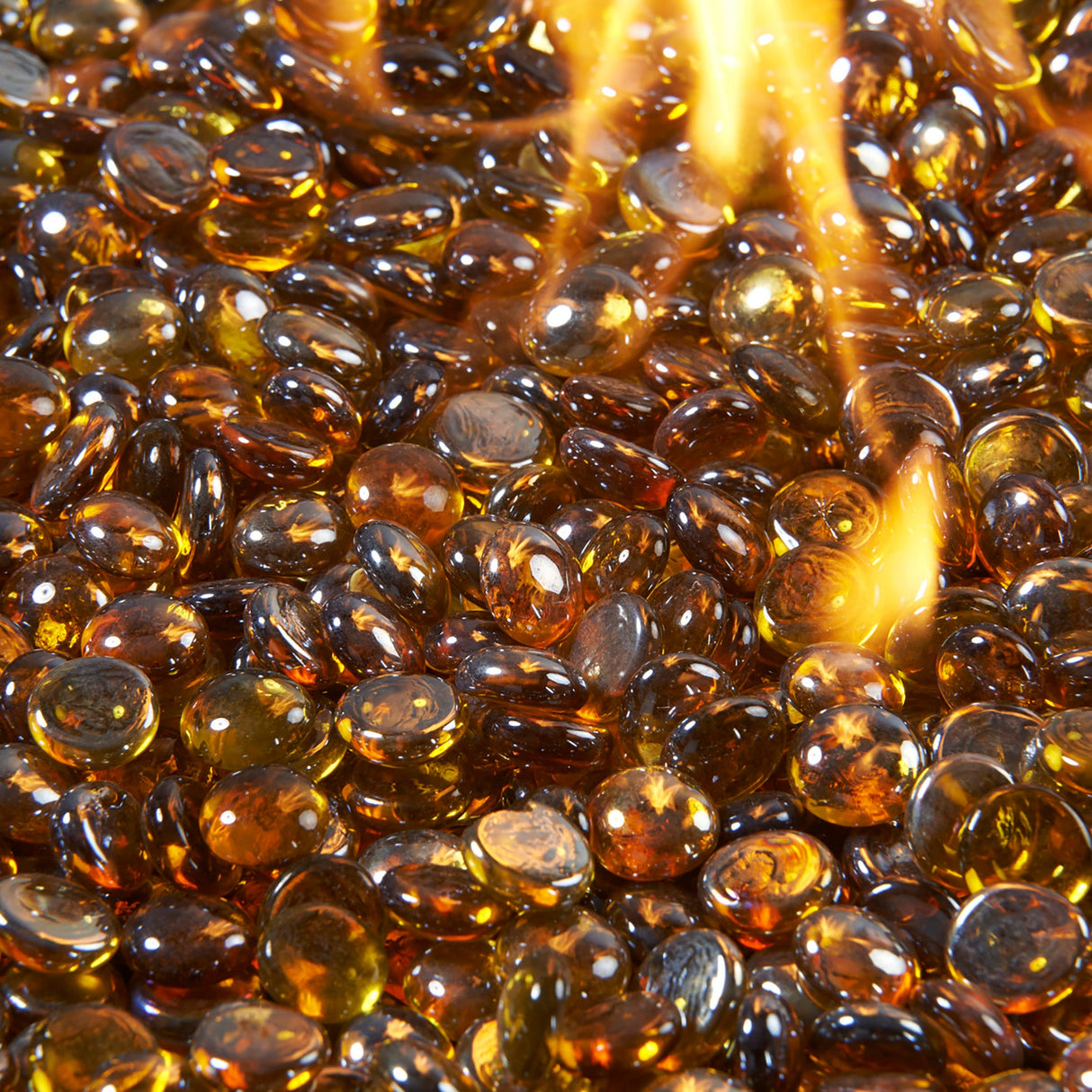 Close up of a flame coming through Amber Tempered Fire Glass Gems for a Crystal Fire Burner