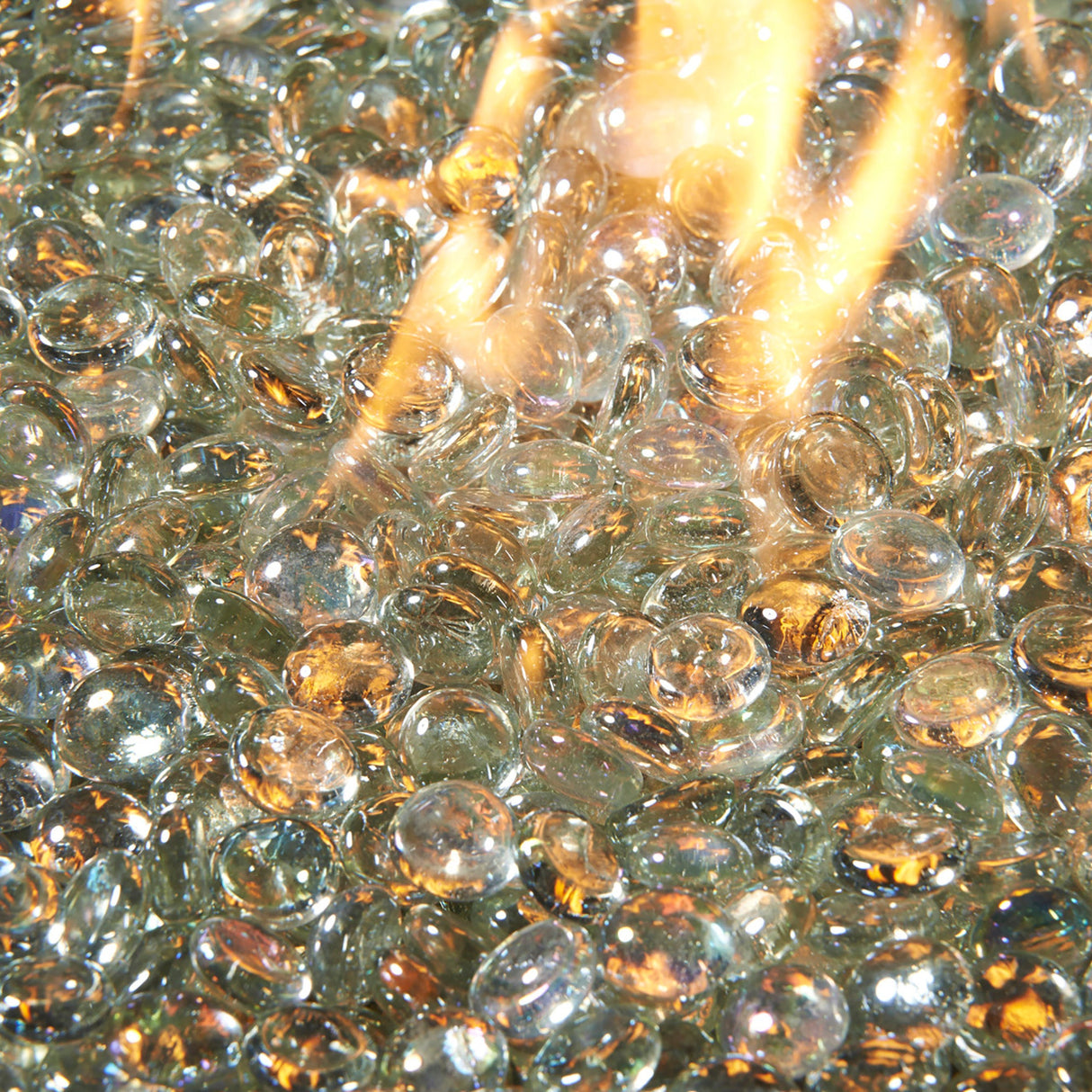 Close up of a flame coming through Clear Tempered Fire Glass Gems for a Crystal Fire Burner