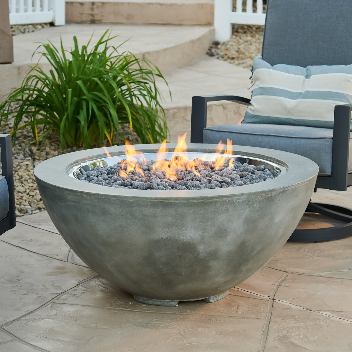 Lava Rocks covering the burner of a Natural Grey Cove Round Gas Fire Pit Bowl 42"