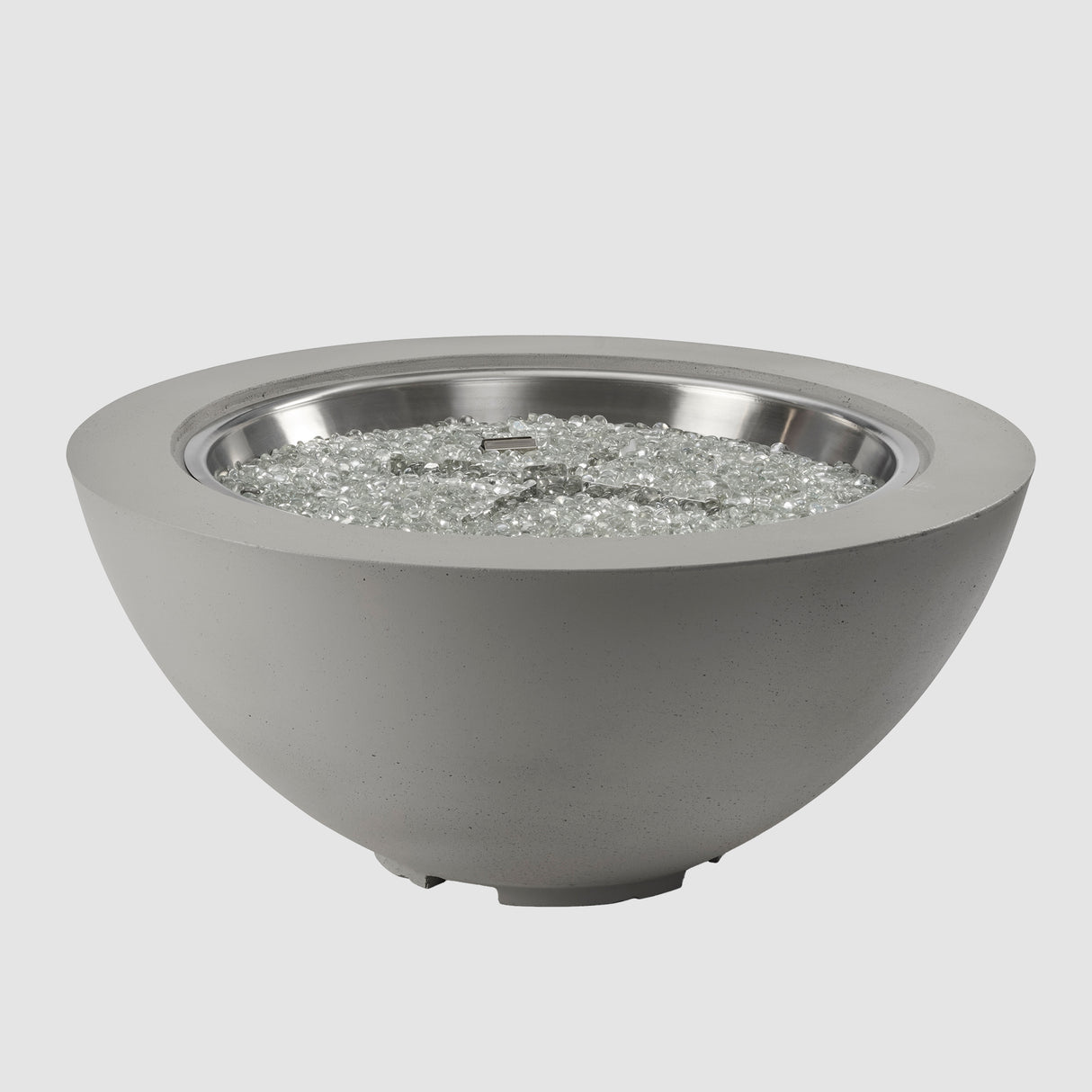 Fire gems on the burner of a Cove Round Gas Fire Pit Bowl 42" on a grey background