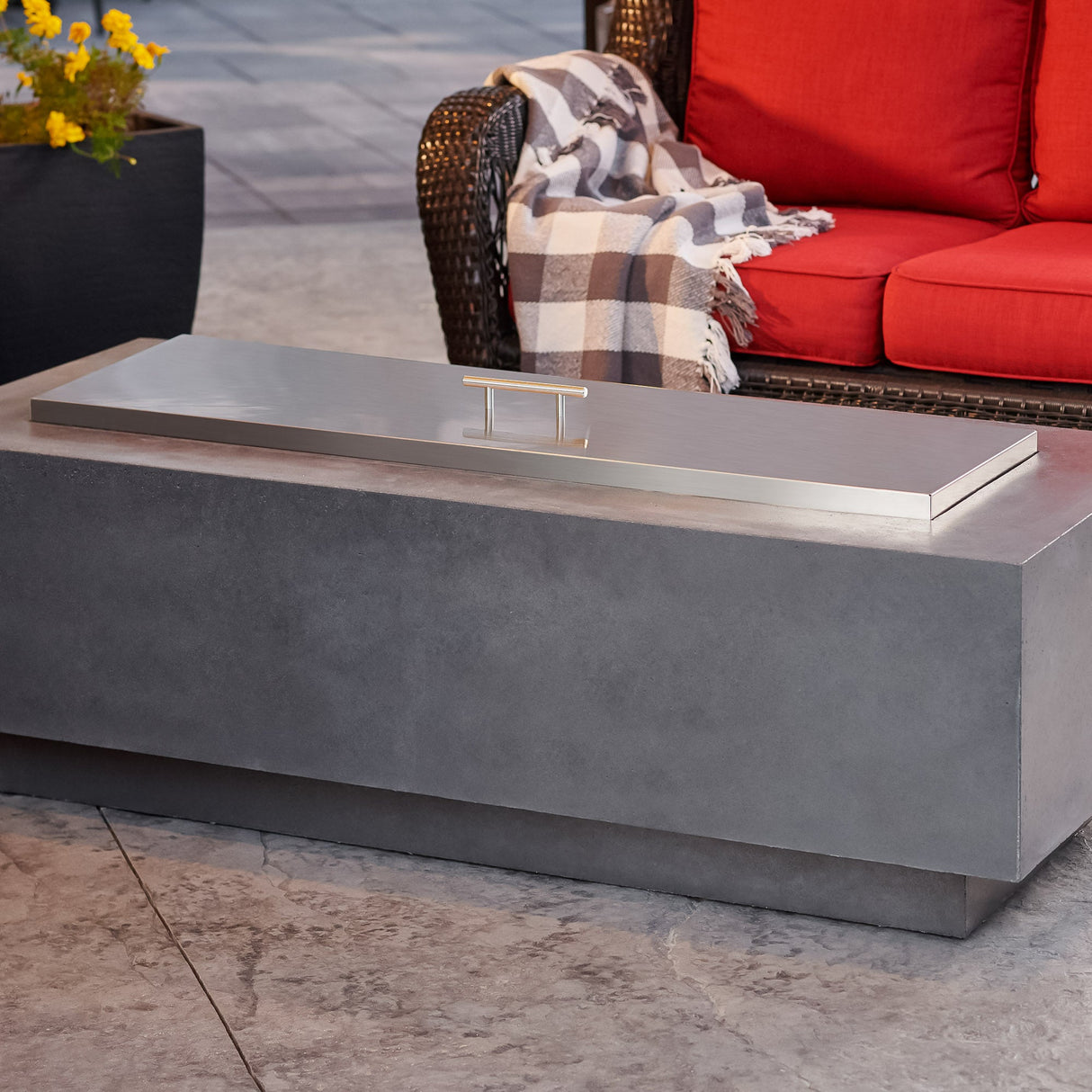 A Stainless Steel Burner Cover placed on top of the Midnight Mist Cove Linear Gas Fire Pit Table 54"