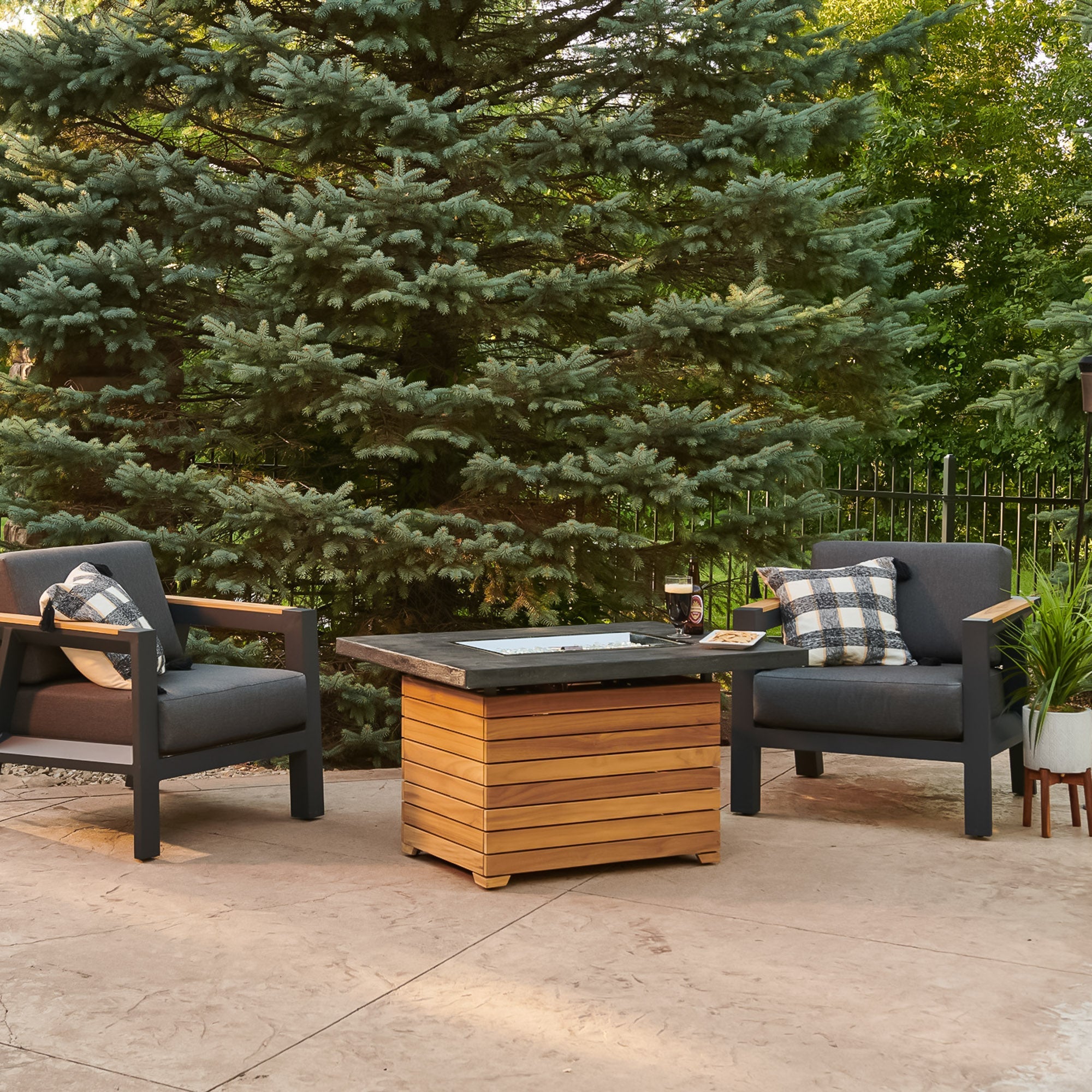 The Darien Rectangular Gas Fire Pit Table being used as a table with drinks and food on the Everblend top