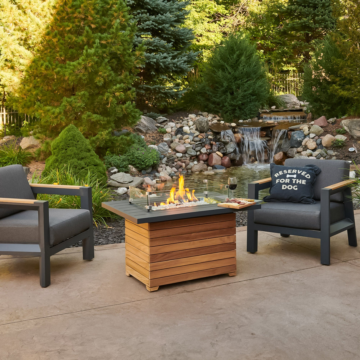 The Darien Rectangular Gas Fire Pit Table being used as a functional table with food and drink on the Aluminum top