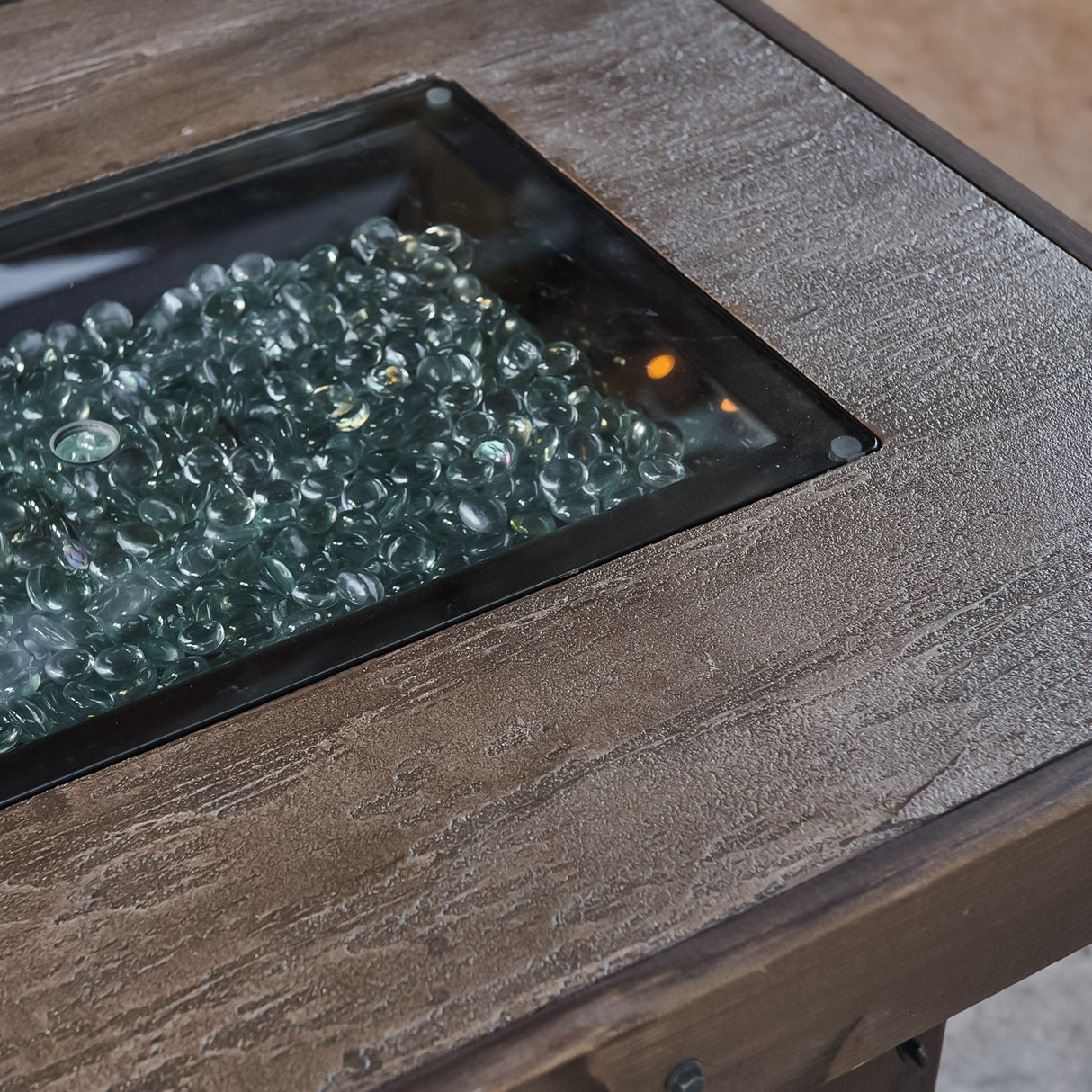 A close up view of the detail found on the top of the Denali Brew Linear Gas Fire Pit Table