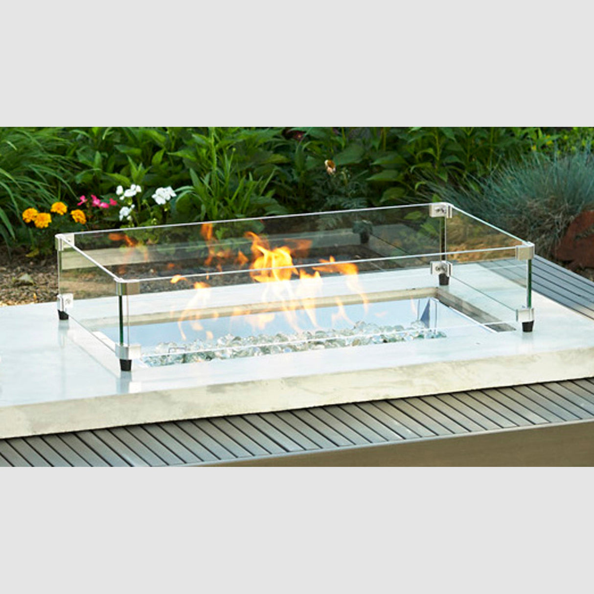 The Rectangular Glass Wind Guard in an outdoor setting with a large flame coming from the burner