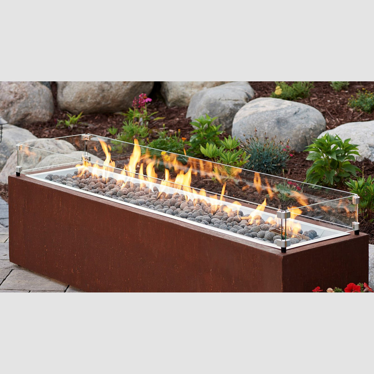 The Linear Glass Wind Guard being used in a patio setting to protect the flame from the burner