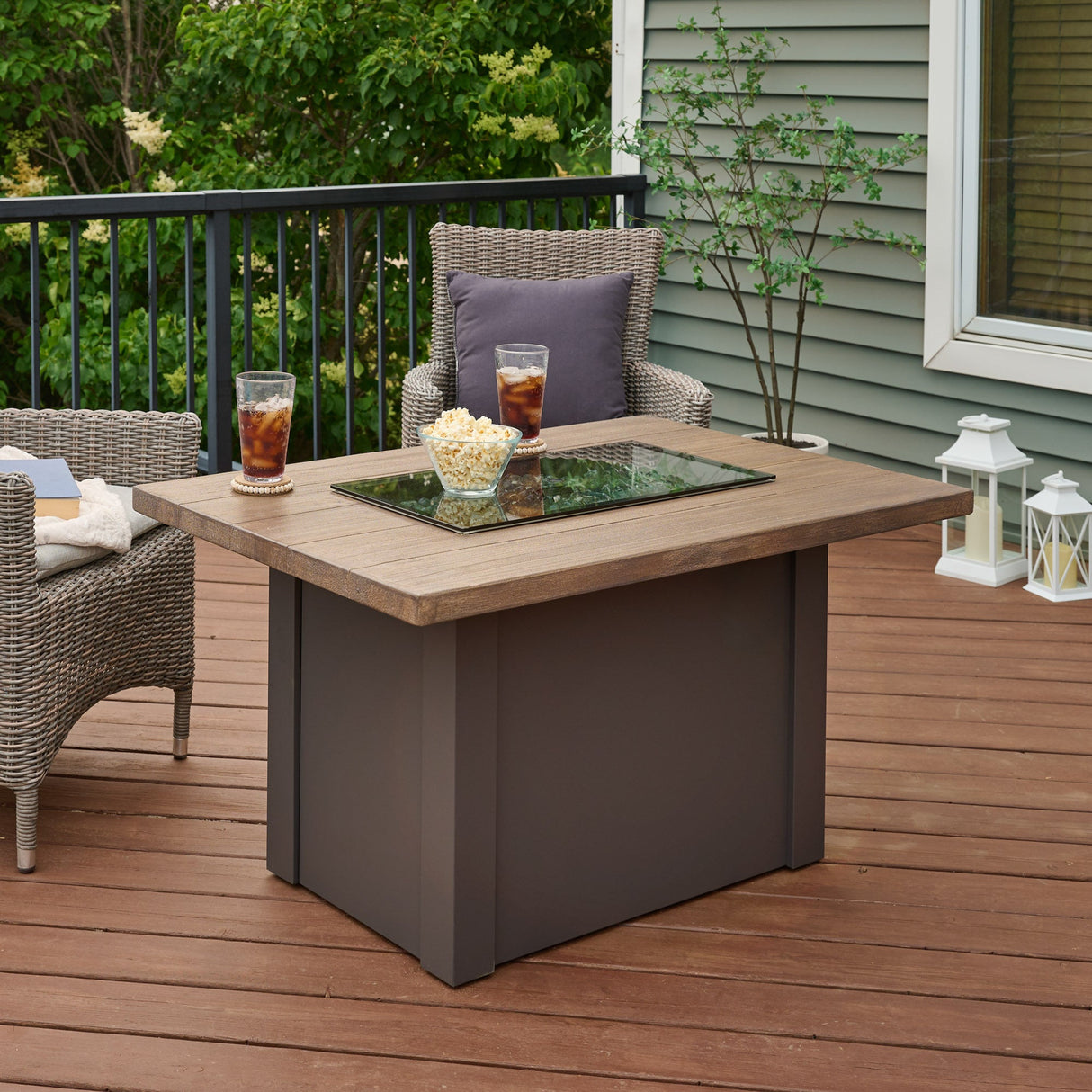 Food and drink placed on top of a Havenwood Rectangular Gas Fire Pit Table on a patio setup