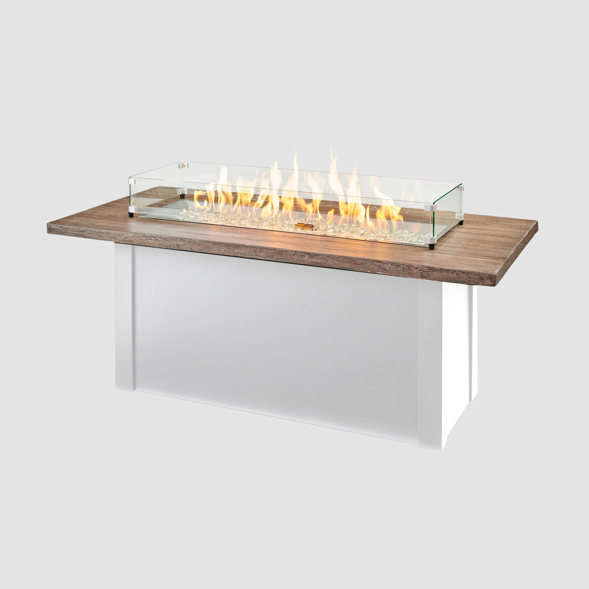 A glass wind guard placed on the top of a Havenwood Linear Gas Fire Pit Table with a Driftwood top and White base
