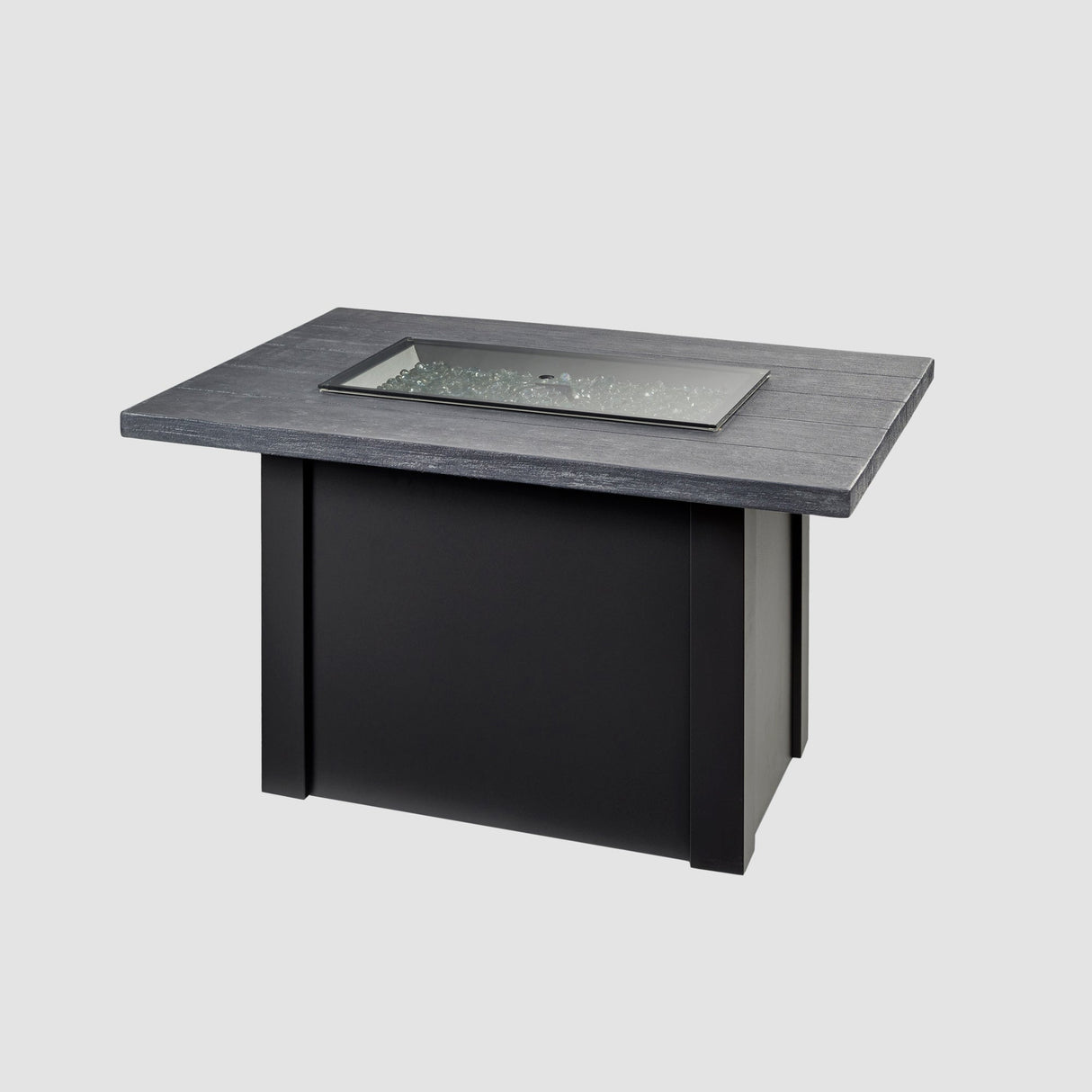 A grey glass burner cover placed on the top of a Havenwood Rectangular Gas Fire Pit Table with a Carbon Grey top and Luverne Black base