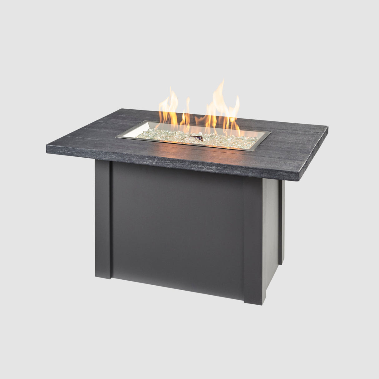A large flame coming off the burner of a Havenwood Rectangular Gas Fire Pit Table with a Carbon Grey top and Graphite Grey base
