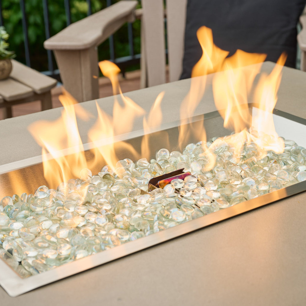 A close up view of the burner and flame from a Havenwood Rectangular Gas Fire Pit Table