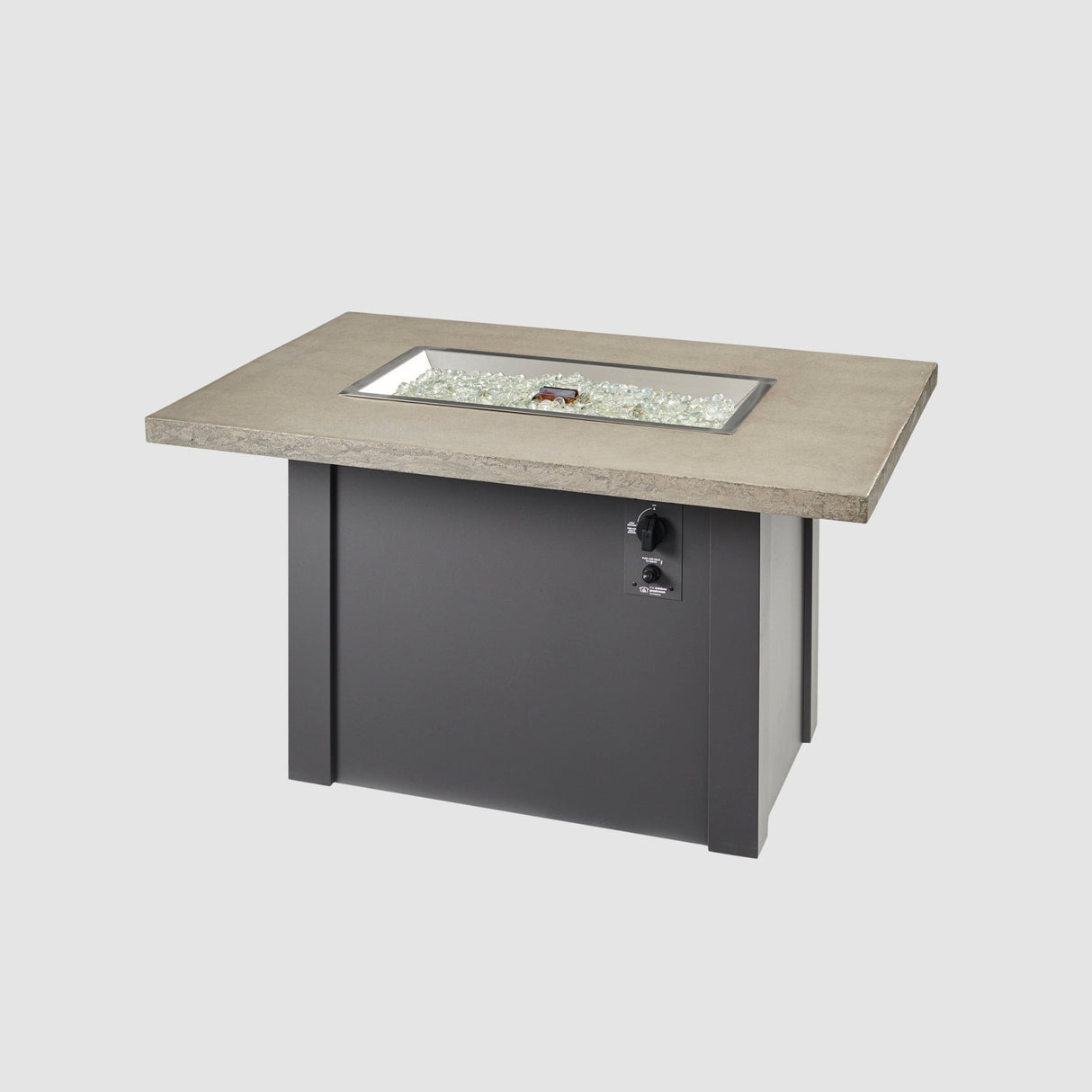 Fire gems placed on the the burner of a Havenwood Rectangular Gas Fire Pit Table with a Pebble Grey top and Graphite Grey base