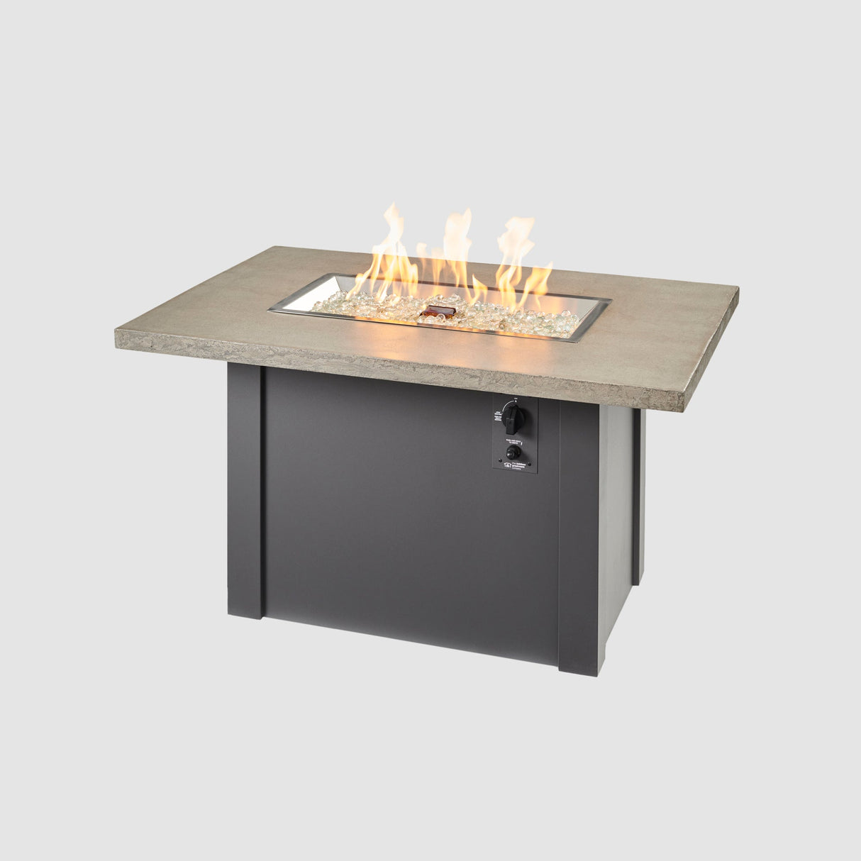 A large flame coming off the burner of a Havenwood Rectangular Gas Fire Pit Table with a Pebble Grey top and Graphite Grey base