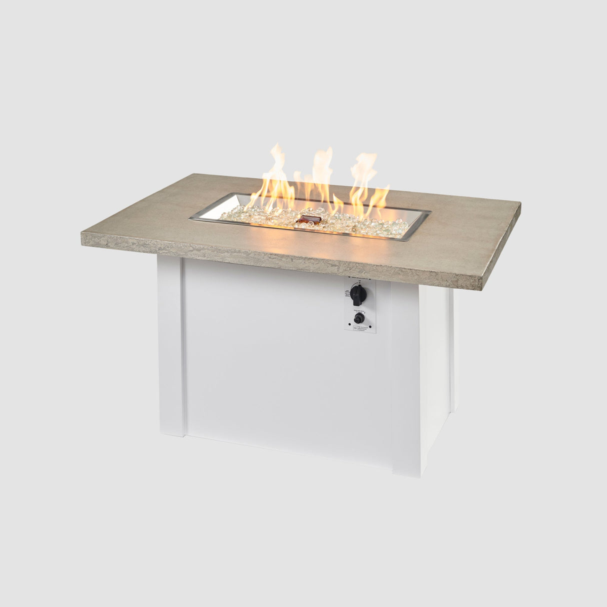 A large flame coming off the burner of a Havenwood Rectangular Gas Fire Pit Table with a Pebble Grey top and White base
