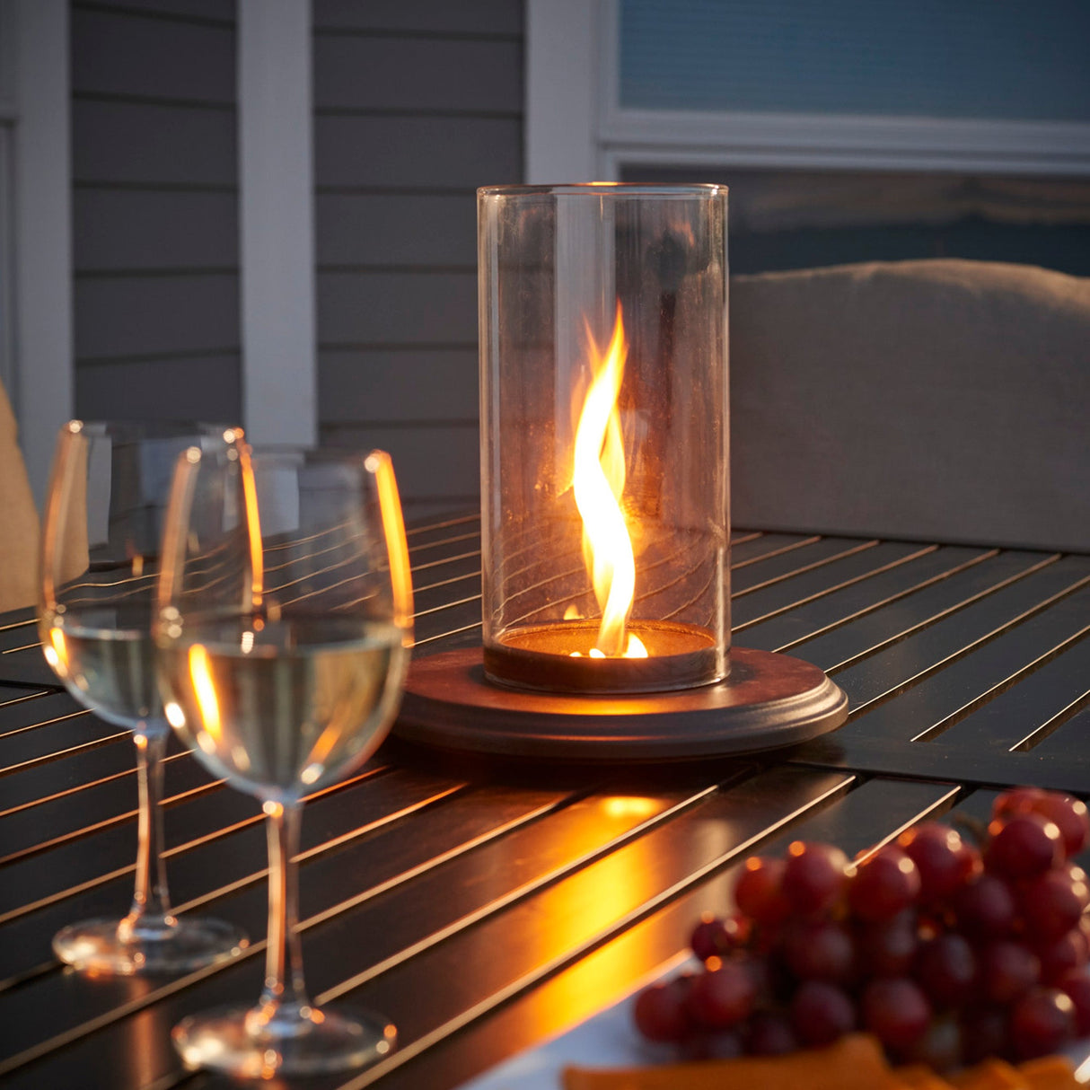 Close up of the flame from the Intrigue Table Top Outdoor Lantern on a table