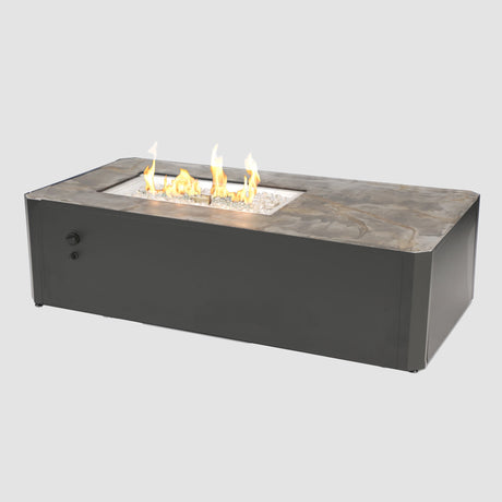 The Kinney Rectangular Gas Fire Pit Table with flame on a grey background