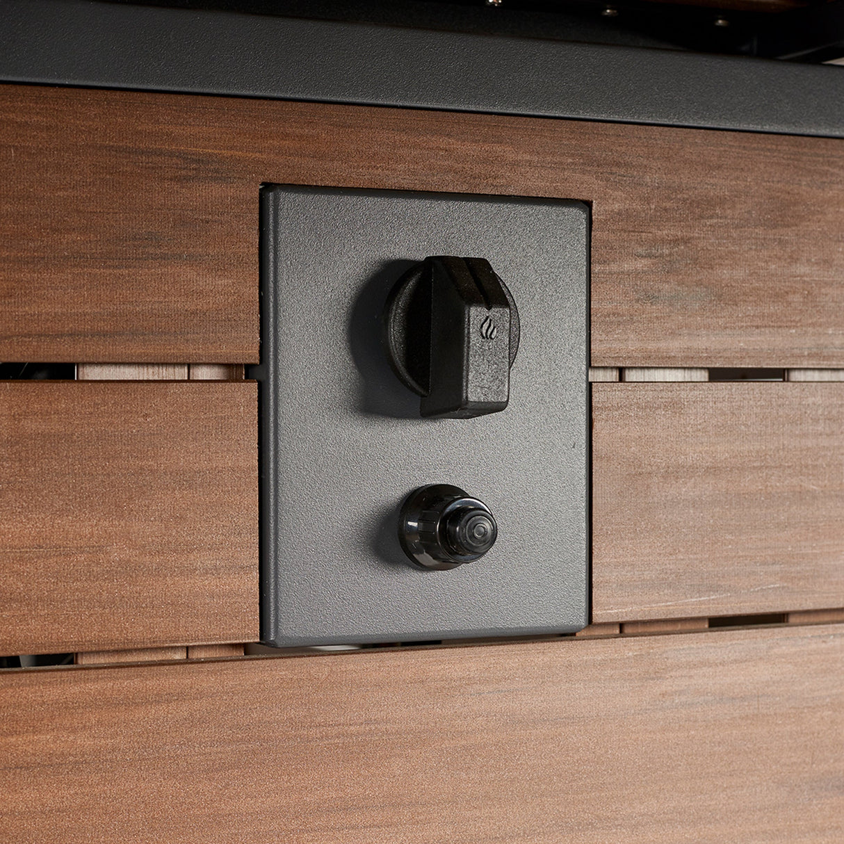 A close up view of the control panel of the Kenwood Linear Dining Height Gas Fire Pit Table