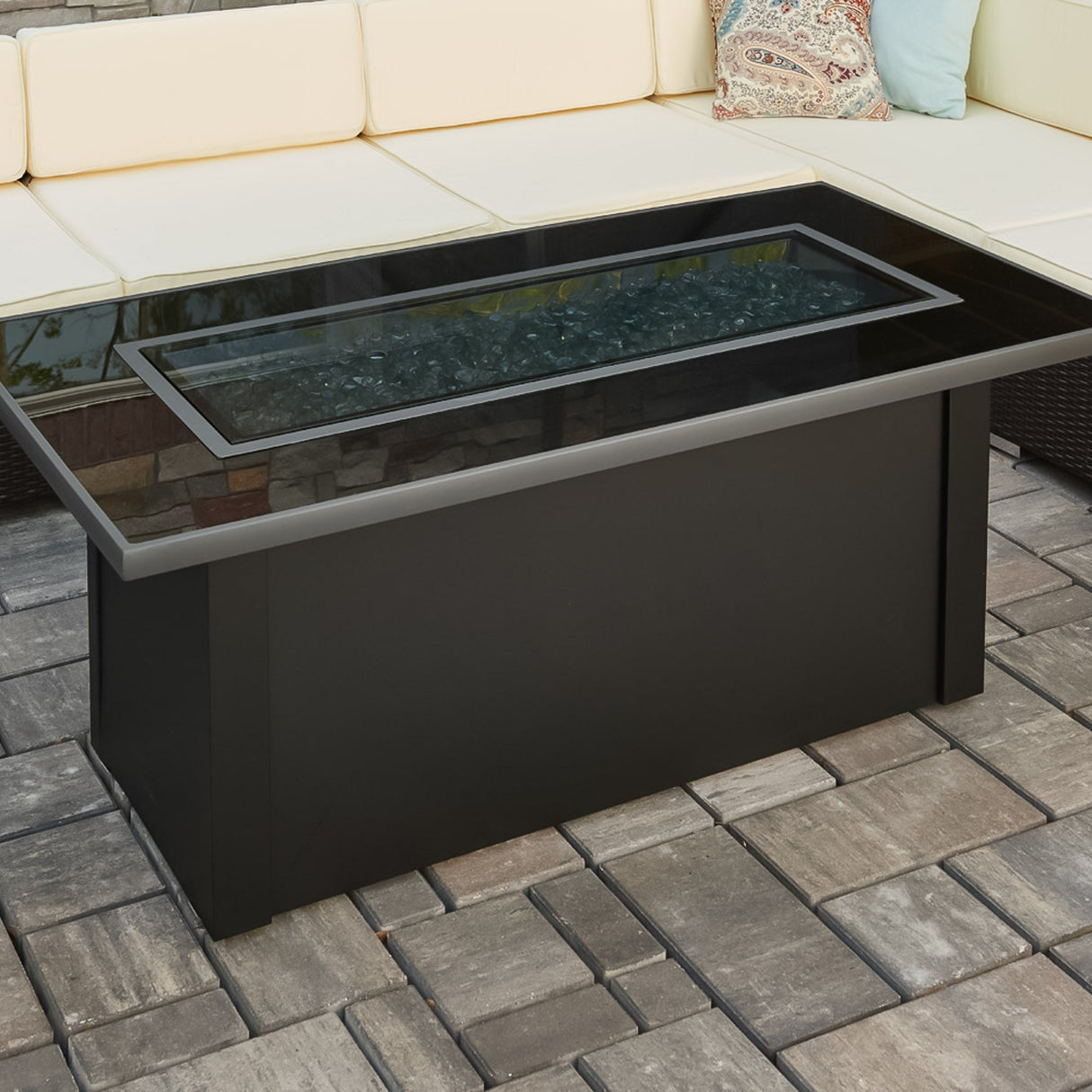 The glass cover placed on top of the Monte Carlo Linear Gas Fire Pit Table allowing it to be used as an outdoor table