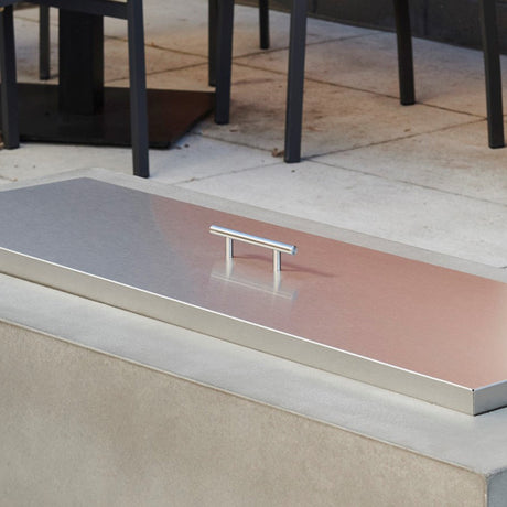 The Stainless Steel Burner Cover being used in an outdoor patio setting