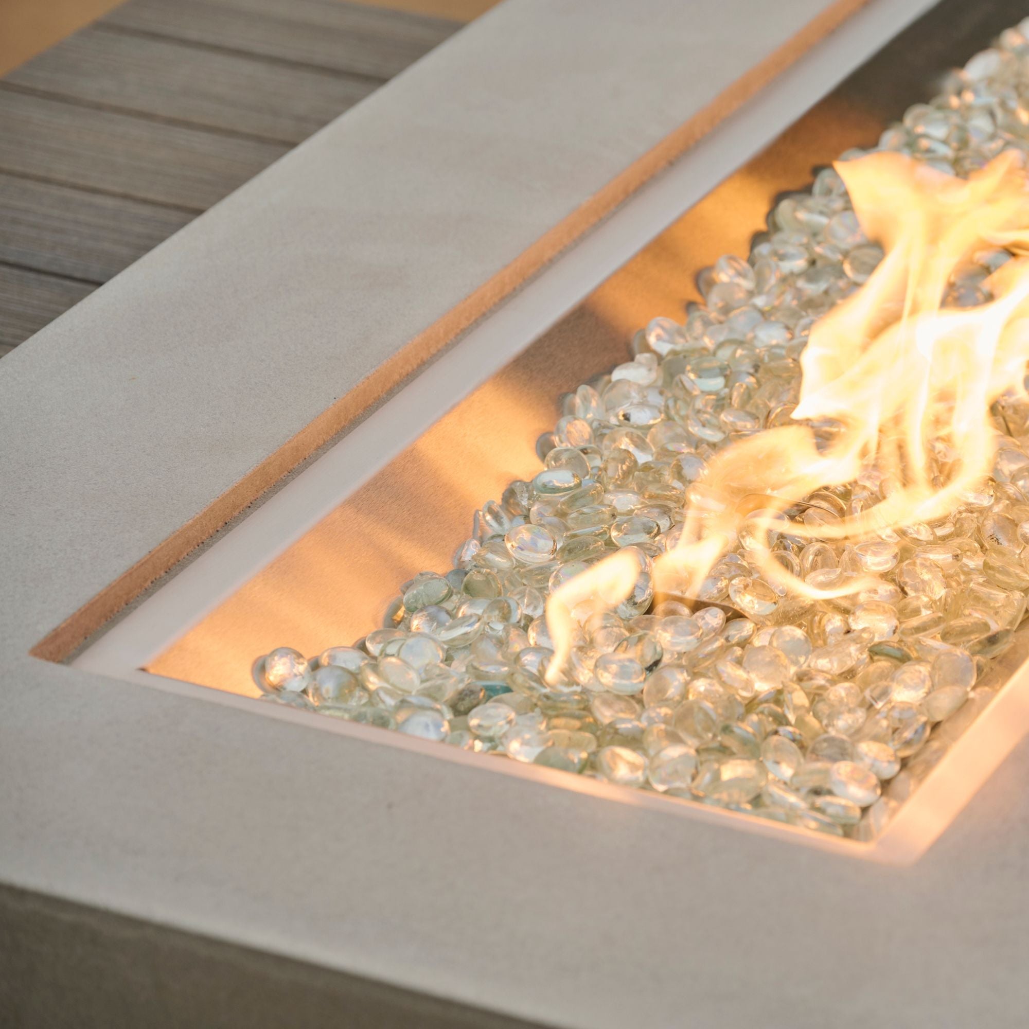 A close up of the flame produced by the Uptown Coastal Grey Linear Gas Fire Pit Table