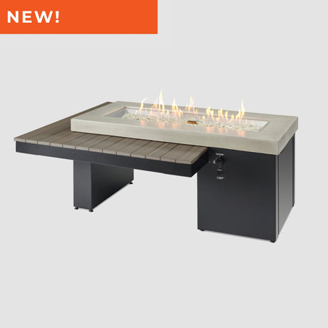 The Uptown Coastal Grey Linear Gas Fire Pit Table with flame.