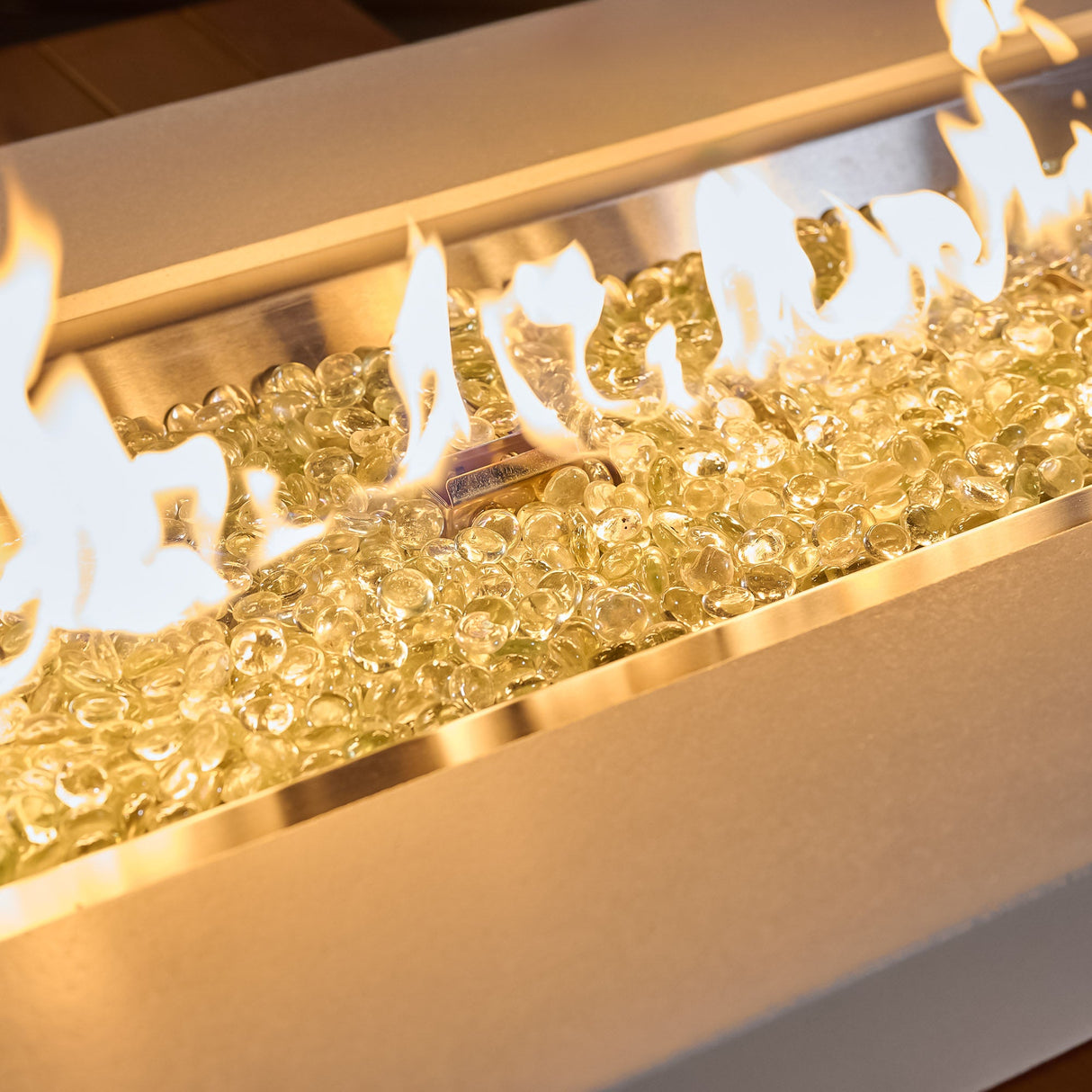 A close up of the flame produced by the Uptown Iroko Linear Gas Fire Pit Table