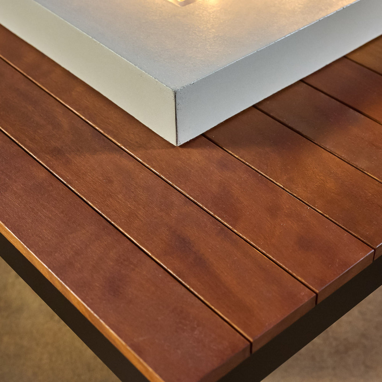 A close up view of the Iroko wood used on the Uptown Iroko Linear Gas Fire Pit Table