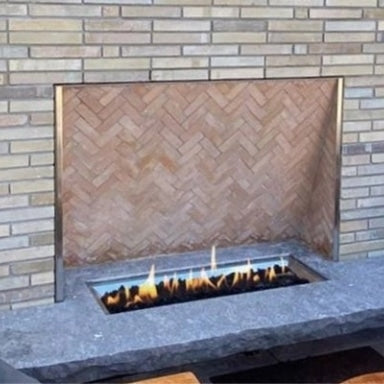 A custom linear gas fire pit table in an outdoor patio