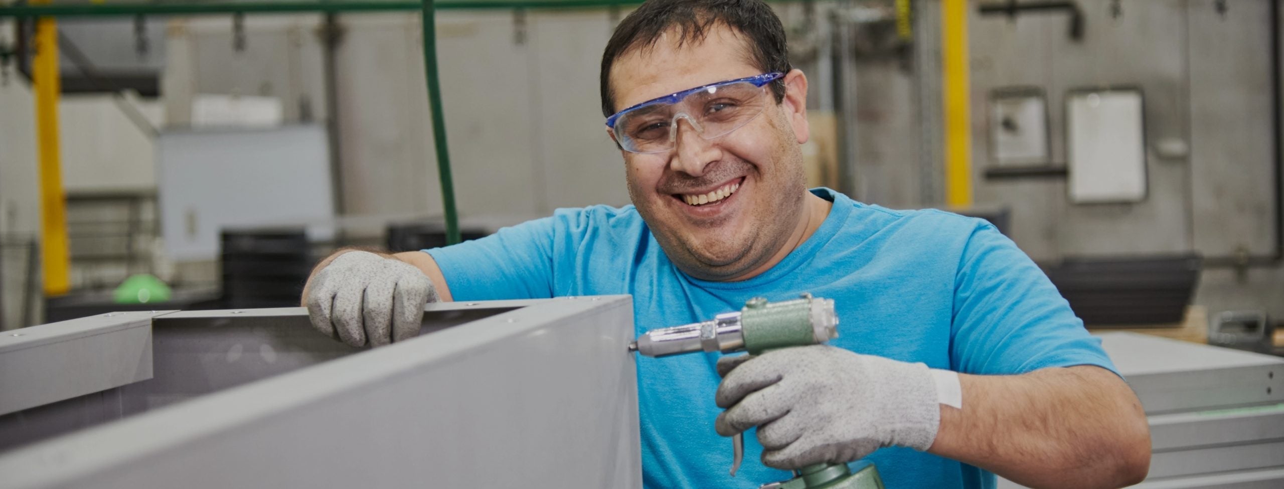 An Outdoor GreatRoom Company employee constructing a fire pit table