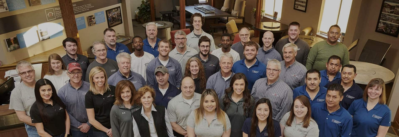 The Outdoor GreatRoom Company team standing next to each other at the Minnesota headquarters