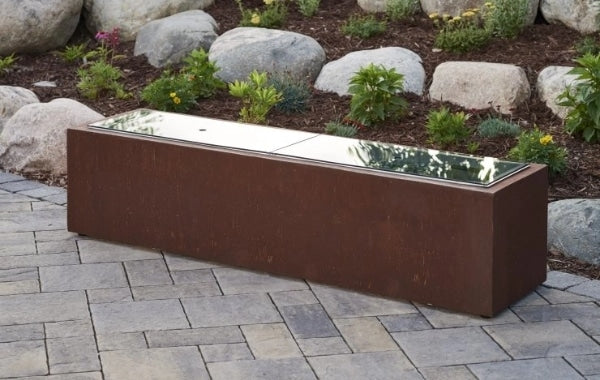 Two glass burner covers placed on a fire pit table