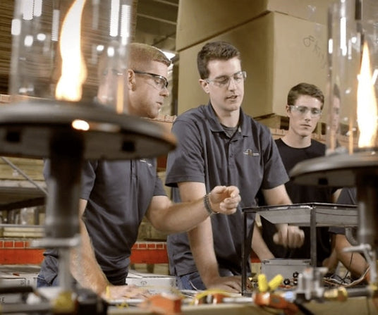 Three Outdoor GreatRoom Company employees working on a Crystal Fire linear gas burner