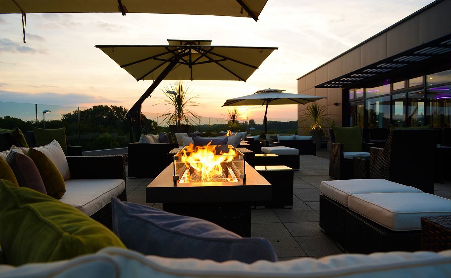 image of fire pit table outside at sunset