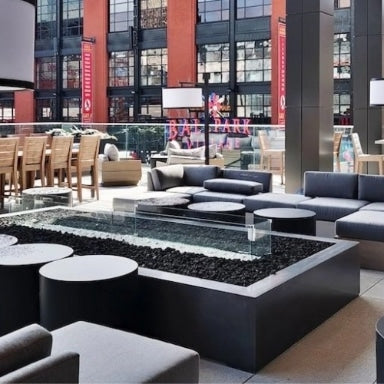 A high end contemporary commercial space with a linear gas fire pit table being used