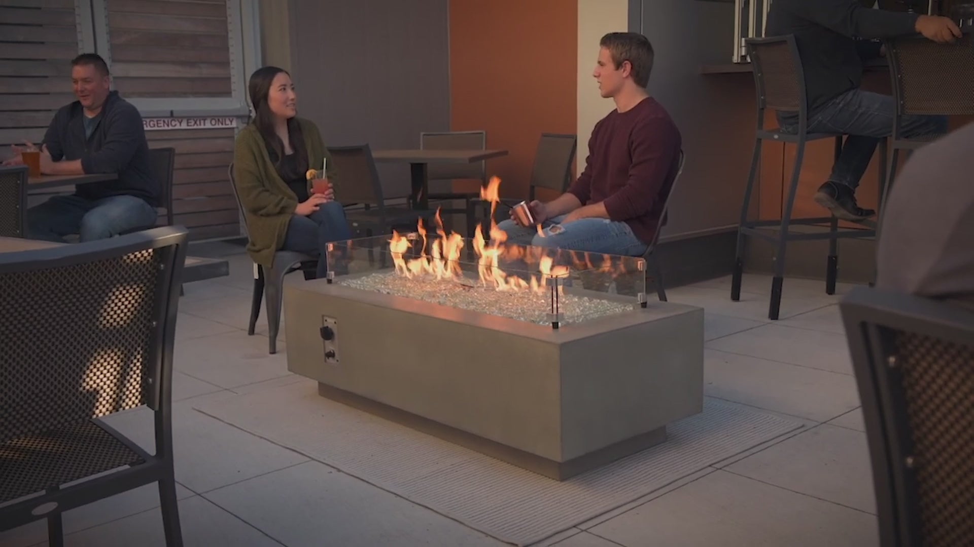 Footage of a variety of gas fire pit tables and accessories available from The Outdoor Greatroom Company. 